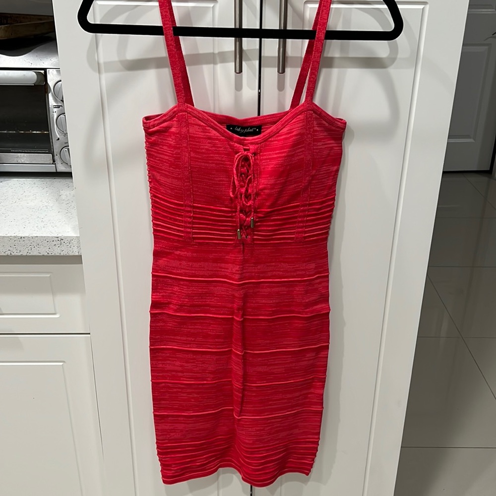 Woman’s size medium, Baby Phat form fitting dress, reddish coral in color